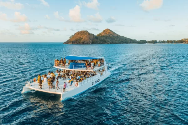 people riding on white boat on sea during daytime